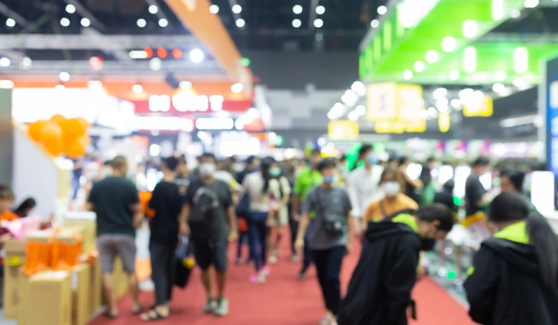 A crowd of people walking around an event.