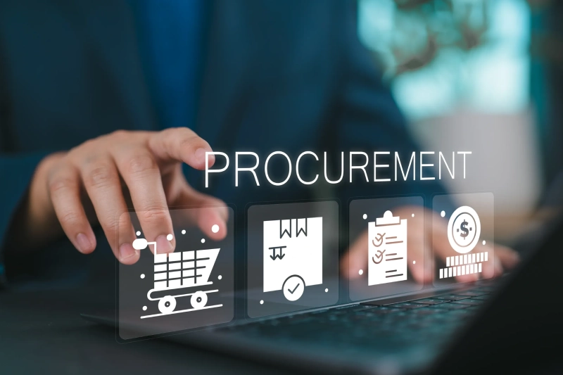 A person is typing on a laptop with the word procurement written in front of them.