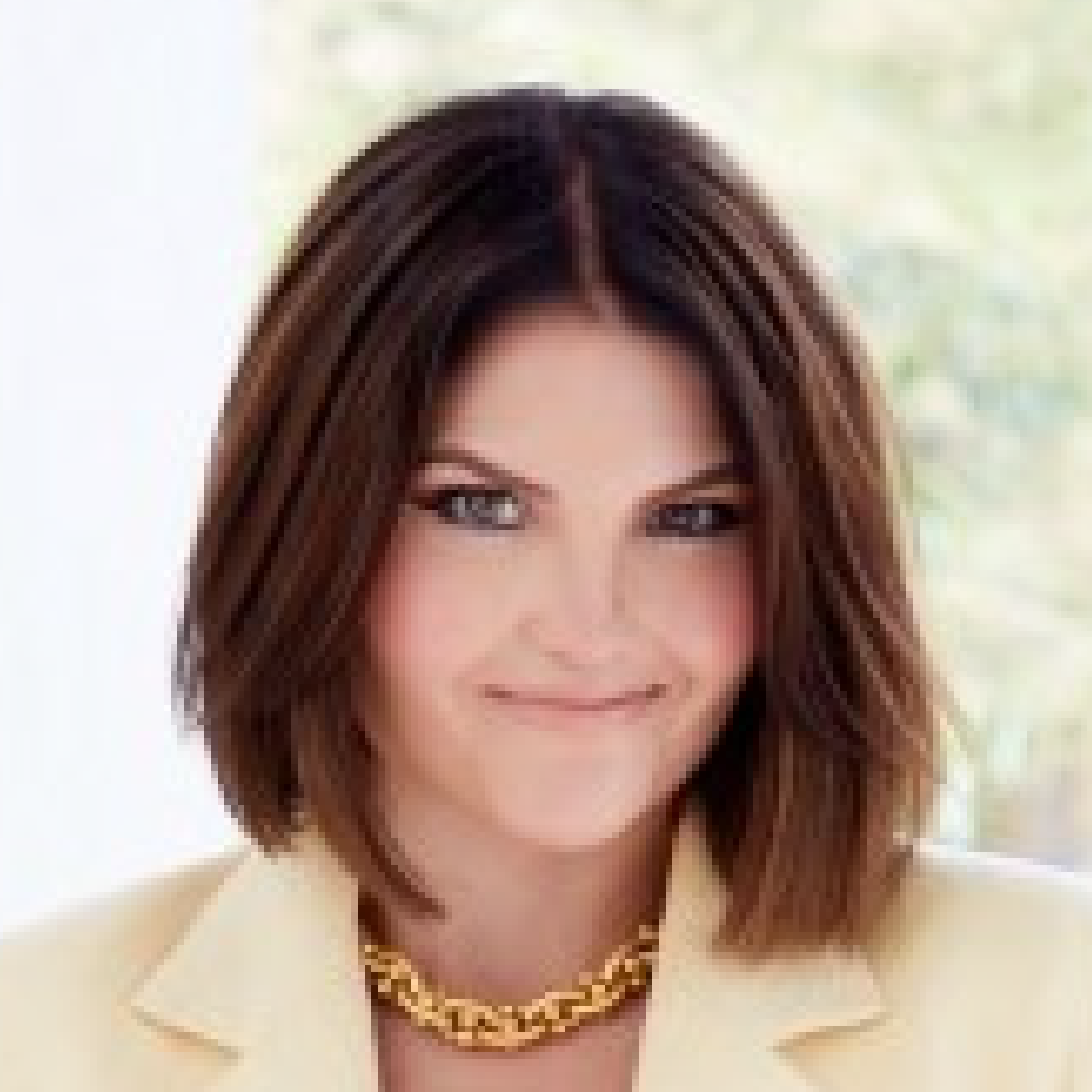 Woman in yellow jacket, smiling gently.