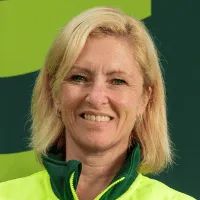 Smiling person in a bright yellow jacket.