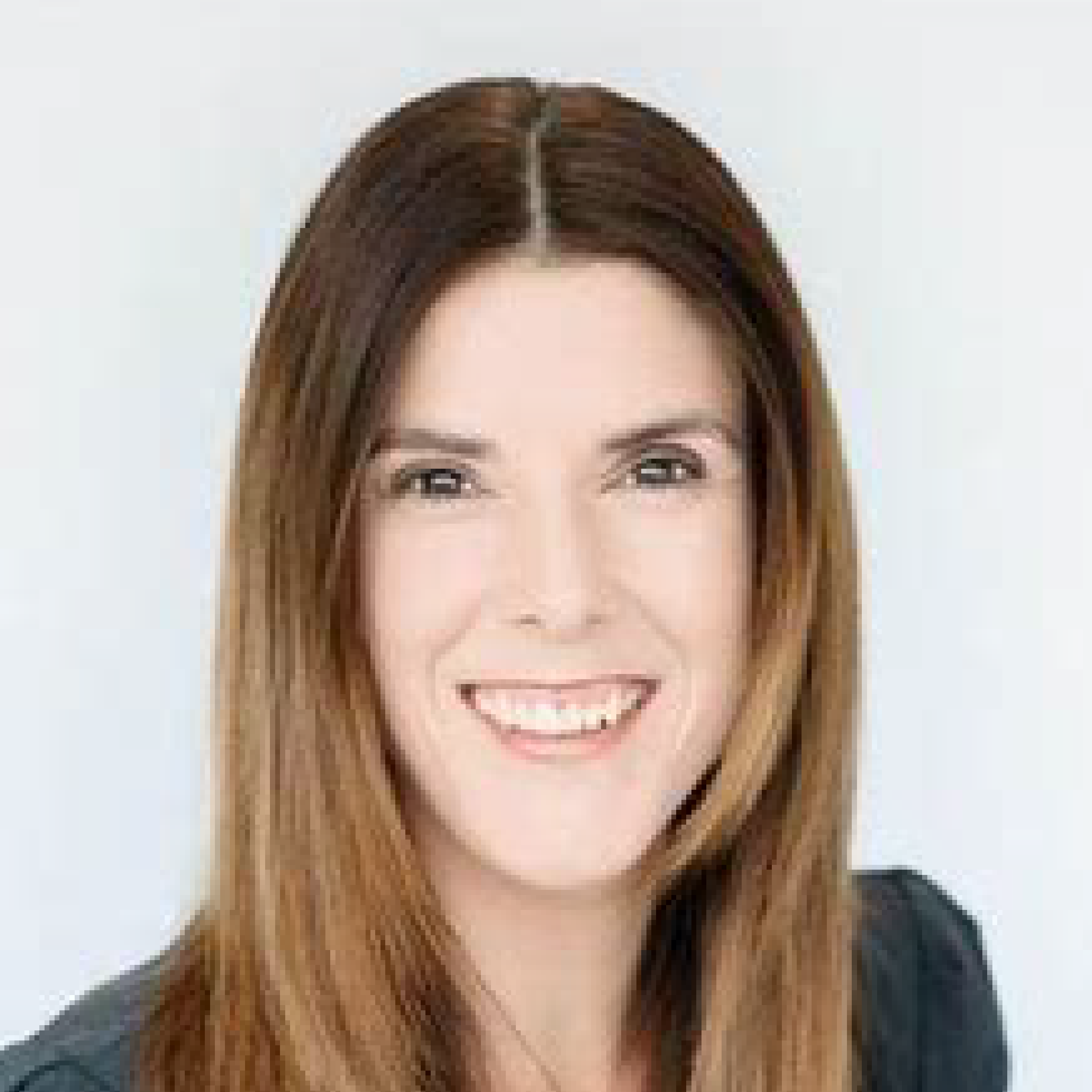 Smiling person with long brown hair.