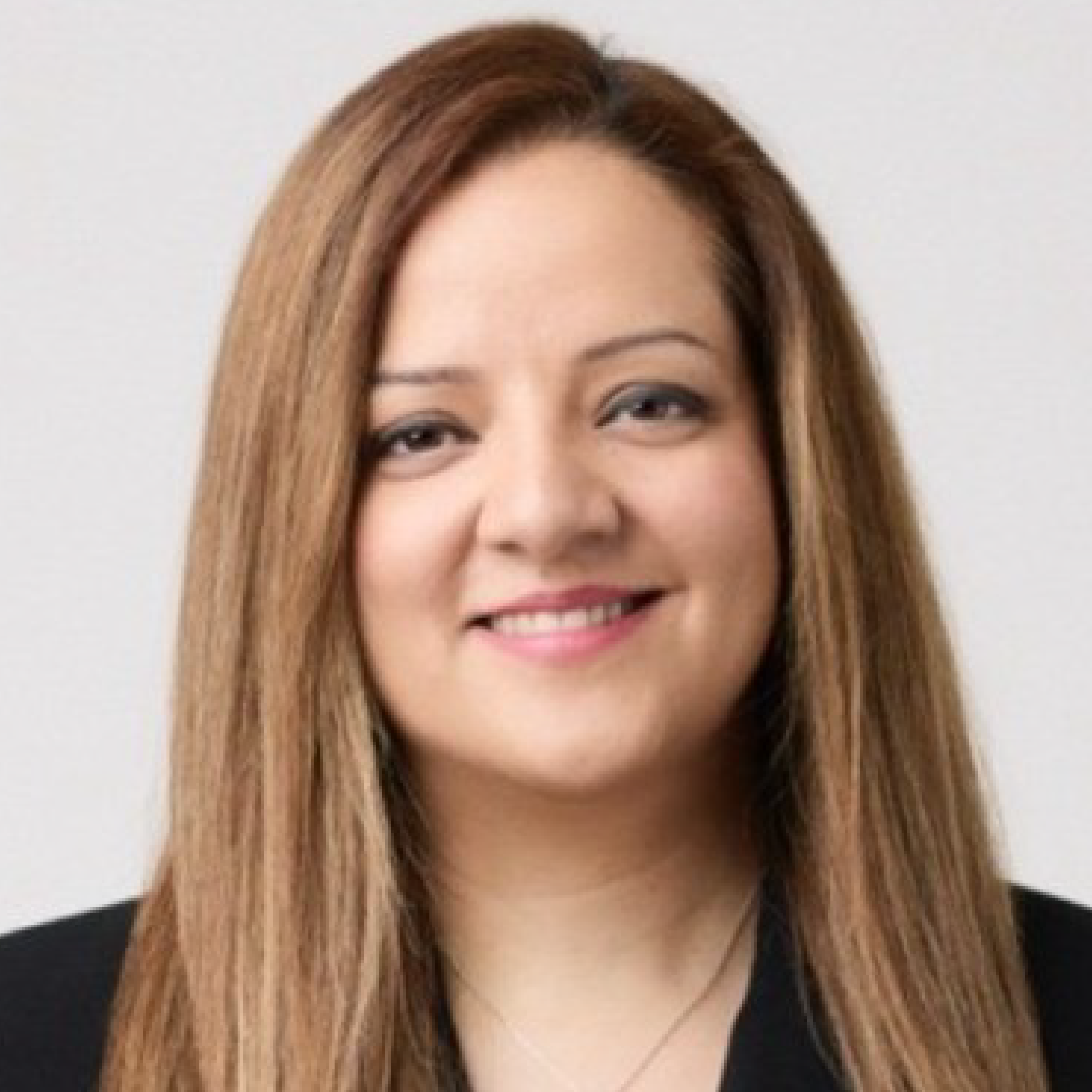 Woman smiling with long brown hair.