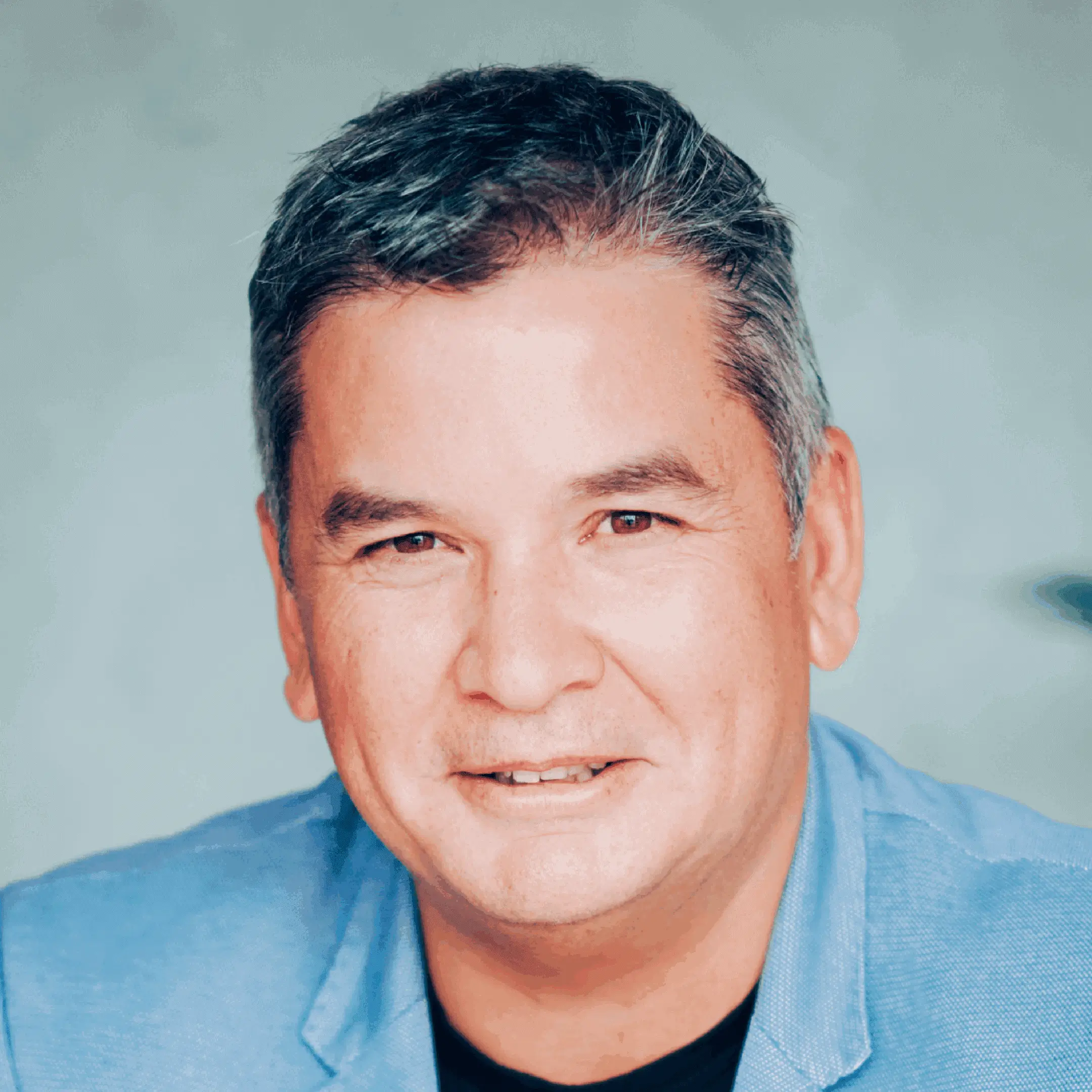 Smiling man in blue jacket portrait.