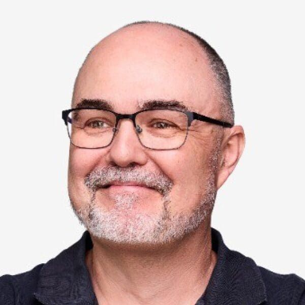 Smiling man with glasses and beard.