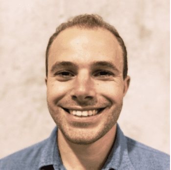 Smiling man in a blue shirt.